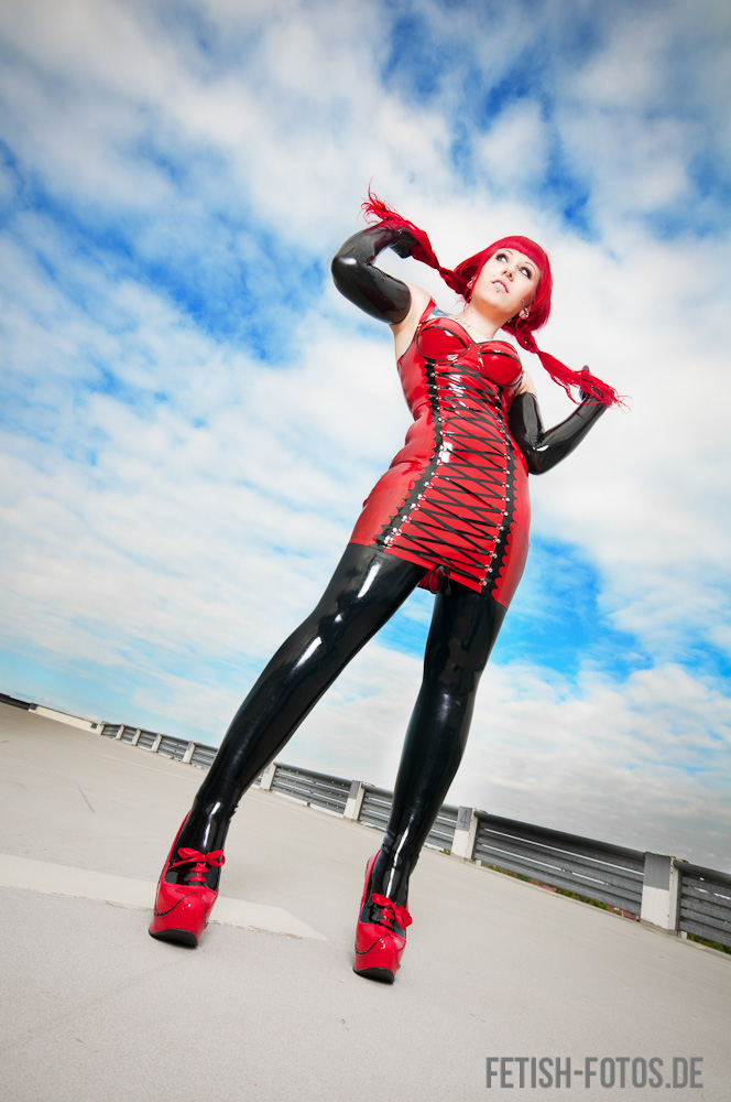Beautiful red and black latex outfit girl with heels